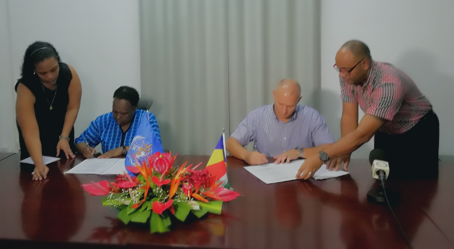 Dr Teniin Gakuruh, acting WHO Liaison Officer and Honorable Jean Paul Adam, Minister of Health signs the framework  