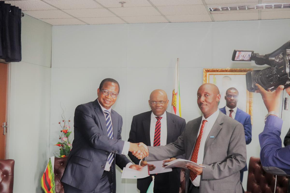 Honorable Minister of Finance and Economic Development Prof. Mthuli Ncube and WR Dr Gasasira shaking hands after signing for the grant