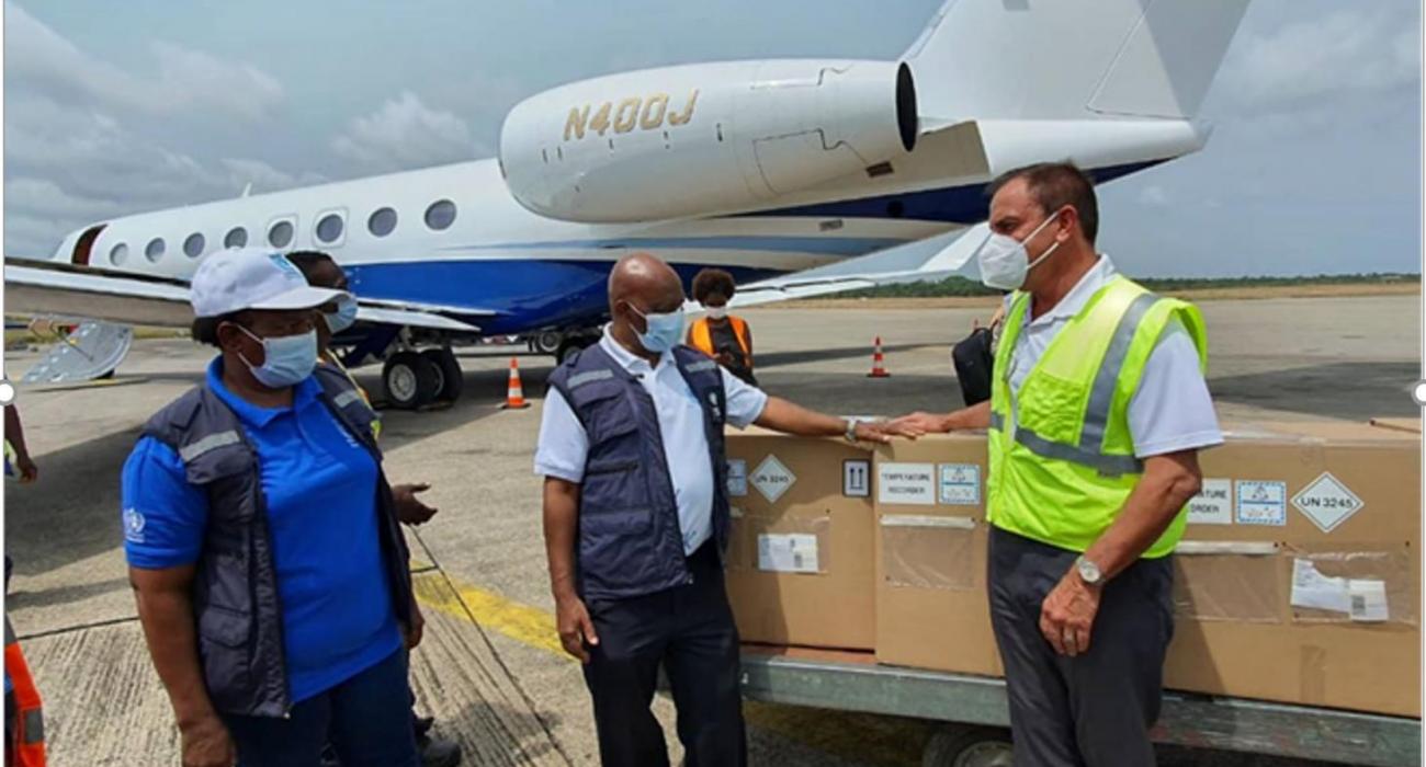 The Piolot of Johnson & Johnson Flight that brought in first batch of the EVD vaccine formally hading over the consignment to the WHO Representative in Sierra Leone at the Lungi International Airport 