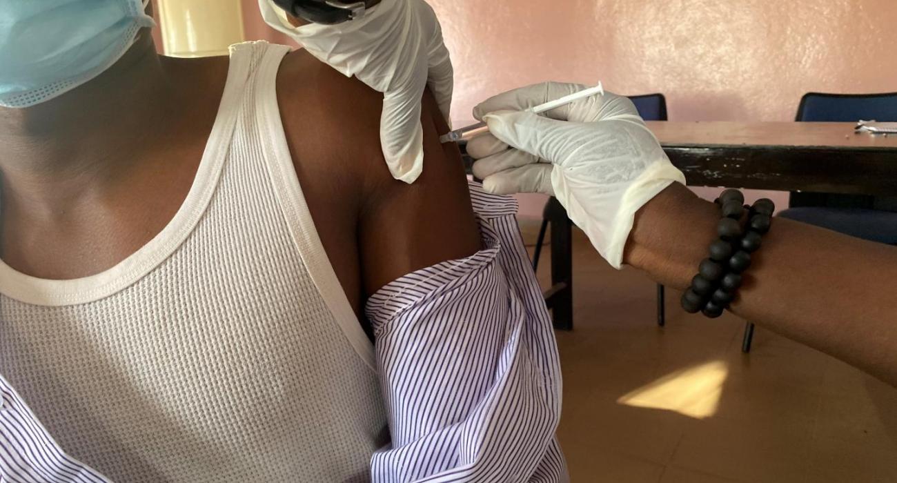 A health worker receiving their first dose on day one of the vaccination