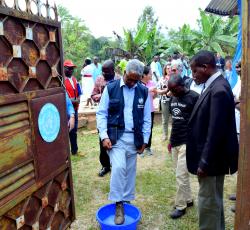 The WHO Representative in Uganda Dr Yonas Tegegn getting a foot bath before entering one of the Ebola Treatment Units