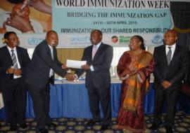 Cabinet Secretary Mr James Macharia awards a certificate to Dr Ephantus Maree, Head of Unit of Vaccine and Immunization Services (UVIS) at the launch of World Immunization week in Kenya, Nairobi. Looking on: Dr Jackson Kioko, Head, DPPHS, Dr Custodia Mandlhate, WHO Country Representative and Dr Nicholas Muraguri, Director of Medical Services