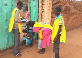 Children receive polio vaccination drops during a house-to-house vaccination campaign in Awiel, South Sudan