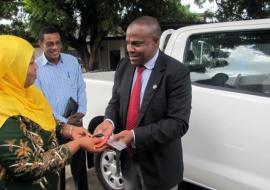 Dr. Martins Ovberedjo on behalf of WHO, handing over keys for the vehicle to the Minister for Regional Administration and Local Government (PMORALG), Hon. Hawa Ghasia (MP)