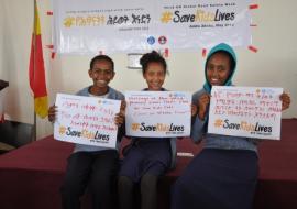 Children calling for action via the #SaveKidsLives signboard