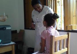 EPI nurse counsels a primary six student before administration of the vaccine at the school.jpg