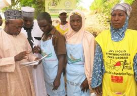 The Zamfara state Commissioner for Health checking a tally sheet at border post