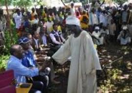 One of the community elders making a round of greetings. Dr Jean-Baptiste Roungou pictured in a hand-shake with the elder.