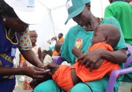 A child receives an injection as part of the package offered by WHO to mark UN Day.