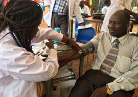 Dr Bakhit Mawien, Director General Wau Teaching Hospital donating blood. He said,  We can live without one arm or one eye but cannot live without blood 