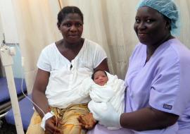 Midwife holding newborn after delivery