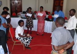 A Training of the Trainers session on strengthening the health sector's response to violence against women in Uganda. Participants learn how to improve their referral plans by learning about the difficulties survivors face when being referred to various services.