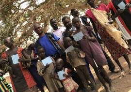 Dr Wamala in a group photo with the vaccinated community members