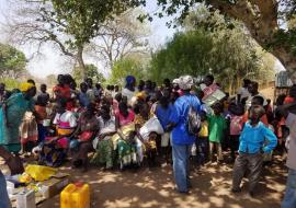 Women with their children waiting in line for a vaccination