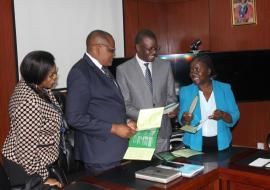 The WHO representative, dr. Nathan Bakyaita (second from right) at MOH when he handed over the MEC Wheel to the Permanent secretary, Dr. Kennedy Malama (second from left)