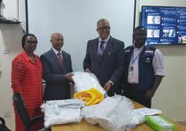 WHO country Representative Dr Wondimagegnehu Alemu hands over personal protective equipment to Chief Executive Officer of the Nigeria Centre for Disease Control Dr Chikwe Ihekweazu