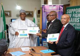 Governor and UN Delegates displaying the signed MOU Document