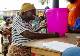 A flood affected victim thankfully receives supplies provided through the one UN support in Dolo's Town, Margibi County