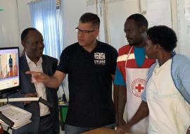 The Acting Director General of Health Services Dr Henry Mwebesa, Hon Alok Shama getting an explanation about the temperature scanners from health workers. 