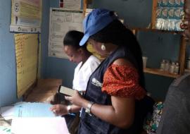 WHO’s Ima Okon and Nurse Sesefu Ayenajeh reviewing the routine immunization register at Aso Pada PHC, Nassarawa State_0.jpg