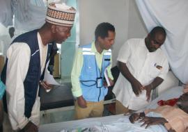 (L-R) Dr Hassan Bala (WHO), Hanibal Abiy OCHA/NHF focal person (and the Chief Nursing officer visiting a  beneficiary of the WHO/NHF fund at the Borno  State Specialist Hospital