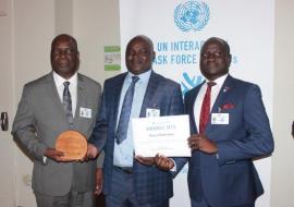 Honorable Minister of Health Jappie Mhango MP holding the UN Interagency Task Force award for NCD prevention and control