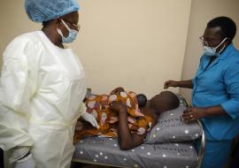 Mr. Shuaibu assisted by healthcare workers  providing skin to skin contact to his baby immediately after birth