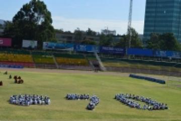 UN@70 in a human stamp drawn by students.