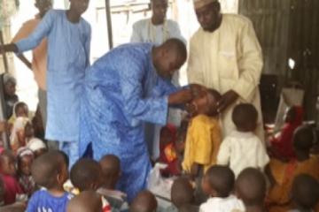 Islamic scholar assisting with Vaccination