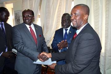 Dr. Usman presents letter of credence to the Minister of Foreign Affairs, Hon. Dr. Benjamin Barnaba while the Minister of Health applauds