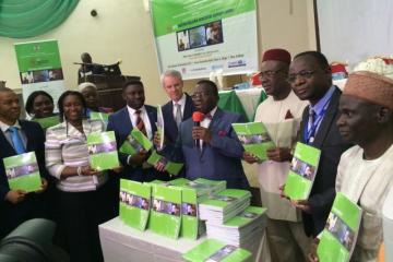 Minister of Health (with microphone) flanked by dignitaries at the MIS launch