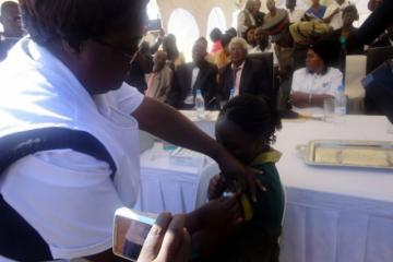 A grade four pupil getting vaccinated