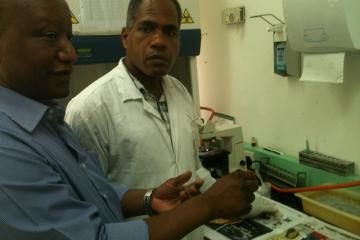 WHO Consultant Dr Mwandawiro discusses specimen processing procedure to one of the Laboratory Technician