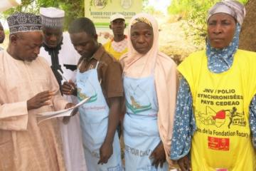 The Zamfara state Commissioner for Health checking a tally sheet at border post