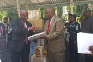 The WHO Representative, Dr. Rufaro Chatora handing over an ECG machine to the Chief Medical Office