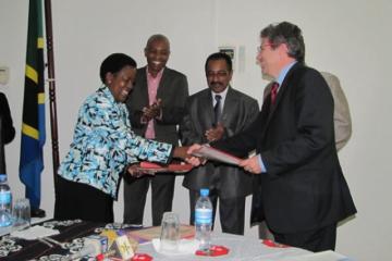 The Head of Operations in the Delegation of the European Union in Tanzania, Mr Eric Beaume, exchanging the signed memorandum of understanding with the Permanent Secretary for Ministry of Health and Social Welfare, Ms. Regina Kikuli during the ceremony.