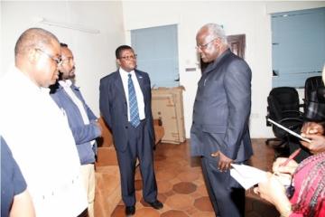 President Koroma, left, at the EOC working station being briefed by Dr Mufunda, WHO Representative