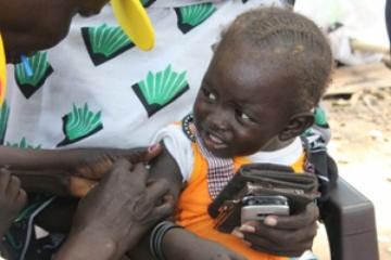 A child recieves measels vaccination at arrival at Juba Port