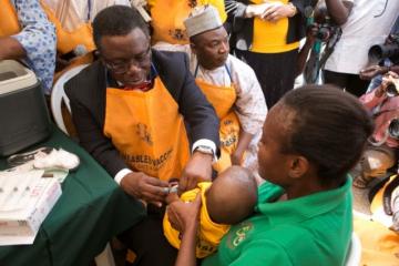 Professor Isaac Florunsho Adewole vaccinating a child to flag-off the 2015 Measles campaign