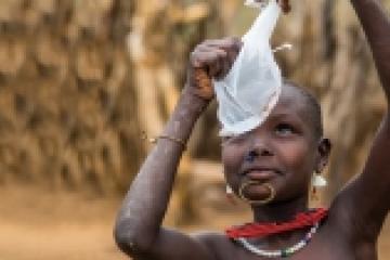 A South Sudanese boy examins a cloth filter The Carter Center