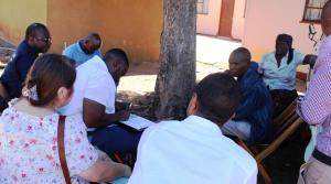 Participants interviewing a community member who once suffered from malaria