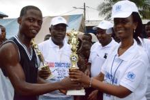  Dr Laetitia  Gahimbare handing over the trophy to the winning basketball team