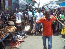 A drama group performing at a market to create awareness on food safety