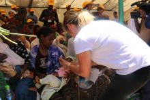 GAVI representative vaccinating a child during vaccination session