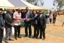 The Minister of Health, Honorable Atupele Muluzi cuts the ribbon as a symbol of launch of the National Alcohol Policy  