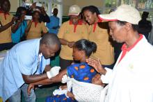 A Community Health Worker providing family planning method to a mother