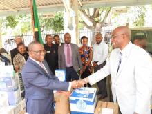 The Permanent Secretary for Health, Dr Mpoki Ulisubisya receiving the items from the WHO Representative, Dr. Adiele Onyeze