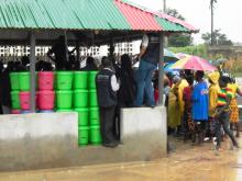 Cross session of flood affected victims receiving supplies provided through the one UN support  