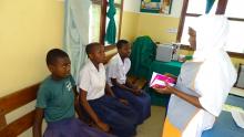 Health Care Worker interacting with the girls before vaccination