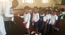 A nurse giving Albendazole to children for de-worming